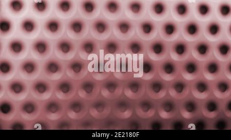 Arrière-plan en métal rose flou avec trous noirs Banque D'Images