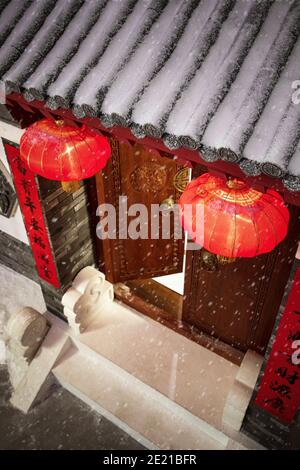 Des lanternes rouges sont suspendues à la neige dans le jardin de style chinois Banque D'Images