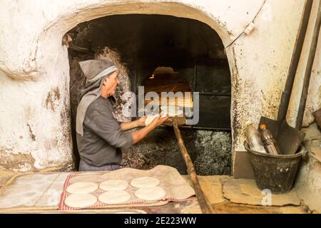 Baker boulangerie Maroc petits pains plats connus sous le nom de khobz. Chaque quartier de la médina dispose d'un four à pain commun. Banque D'Images