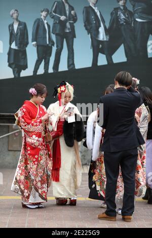 Les femmes vêtues de kimono qui passent du temps à Shibuya Crossing pendant la journée « arrivée de l'âge » en Tokyo.Coming de la Journée de l'âge célèbre ceux qui ont 20 ans. C'est un jour férié le deuxième lundi de janvier au Japon. Cependant, à la lumière du taux croissant d'infection par COVID19 au Japon, le jour de l'âge de 2021 n'était pas le même comme d'habitude. La cérémonie officielle n'était en ligne que dans la plupart des bureaux de la ville au Japon. Dans la place populaire Shibuya Crossing n'était que peu de filles dans le magnifique kimono. Toutes les personnes portant un masque. Banque D'Images