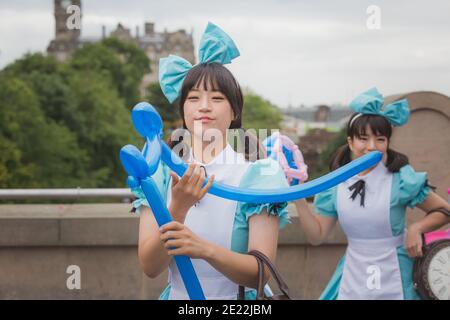 Édimbourg, Écosse - 6 2016 août : des artistes de rue asiatiques façonnent des ballons en musique au Festival Fringe d'Édimbourg. Banque D'Images