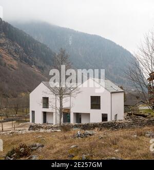 Maison blanche entourée par la nature, la forêt et le brouillard en hiver. Bâtiment dans la vallée suisse. Personne à l'intérieur Banque D'Images