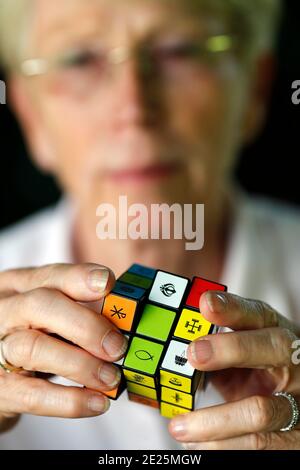 Femme avec un cube de Rubik avec des symboles religieux. Concept de dialogue interreligieux et interreligieux. France. Banque D'Images