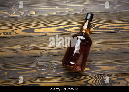 Bouteille de whisky sur fond en bois sombre plat Banque D'Images