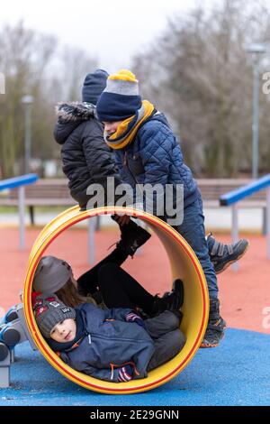 POZNAN, POLOGNE - 10 janvier 2021 : groupe d'enfants jouant dans un tunnel dans un terrain de jeu du parc Rataje. Banque D'Images