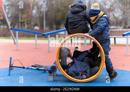 POZNAN, POLOGNE - 10 janvier 2021 : groupe d'enfants jouant dans un tunnel dans un terrain de jeu du parc Rataje. Banque D'Images