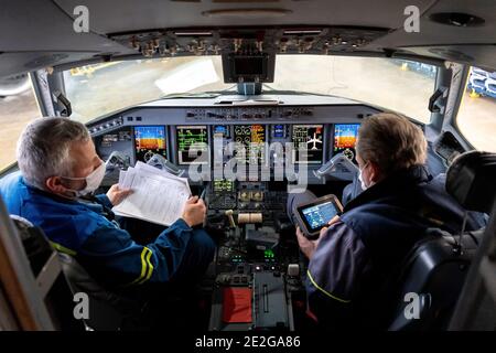 Kiev, Ukraine - 25 novembre 2020 : cockpit d'avion Embraer. Pilotes dans des masques médicaux. Les techniciens diagnostiquent, réparent et réparent l'avion. Travailleurs W Banque D'Images