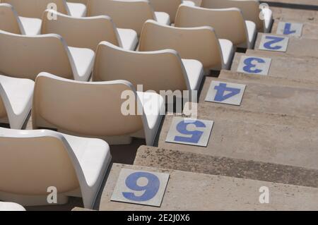 Chaises de stade ou de scène vides en plastique blanc rangées et marches numérotées. Banque D'Images