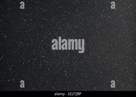 fond abstrait de texture de photo noir et blanc de la surface de revêtement de poudre granuleuse avec des taches blanches Banque D'Images
