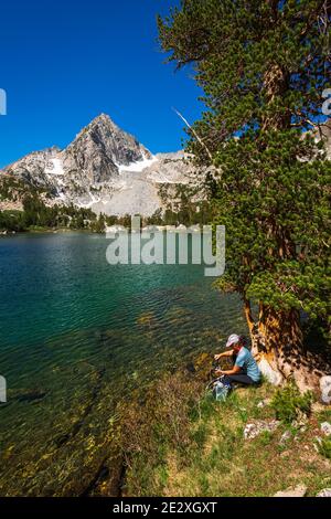 Eau de randonnée purifiante sur les rives du lac Treasure, John Muir Wilderness, Sierra Nevada Mountains, Californie États-Unis Banque D'Images