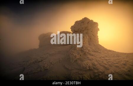 Magnifique lever de soleil orange sur l'ancien observatoire polonais sur le mont PIP Ivan. Paysage d'hiver incroyable avec bâtiment gelé en haut de la montagne. Carpathian montagnes, Ukraine, Europe Banque D'Images