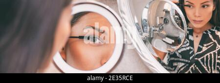 Beauté personnelle LED illuminée miroir de maquillage rond asiatique femme mettant mascara maquillage à la maison salle de bains matin bannière panoramique. Belle fille Banque D'Images