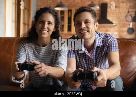 Un jeune couple heureux s'amuse à jouer aux jeux vidéo Banque D'Images