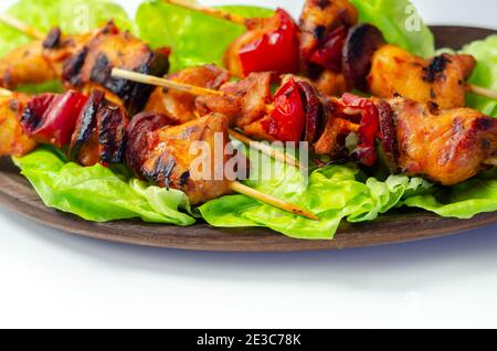 Brochettes grillées au poulet, courgettes, champignons, poivrons et oignons servies sur la laitue iceberg, plats de fête Banque D'Images