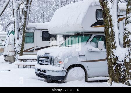 Le 17 janvier 2021 - Roxton Falls, QC, Canada : les véhicules de camping garés de suite sur des terrains de camping pendant la tempête de neige, hivernent, entrevent pour la saison hivernale Banque D'Images