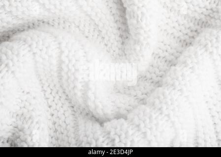Gros plan sur fond blanc tricoté texturé. Couleur tendance. Banque D'Images