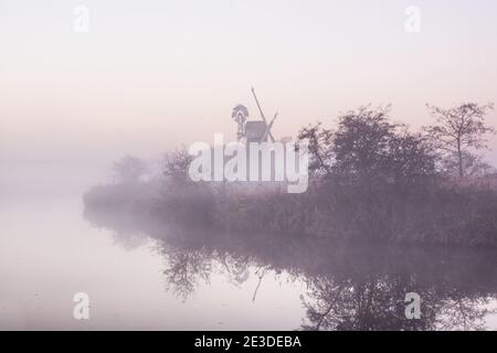 Vue magique d'un moulin à vent dans Norfolk Broads couvert brume Banque D'Images