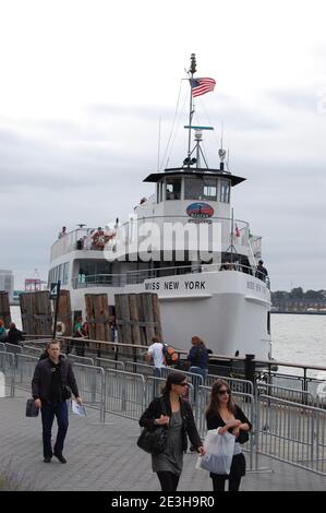 Miss New York bateau de l'île Miss Ellis bateau touristique avec drapeau américain dans le port New York Etats-Unis au départ Ellis Island statue de la liberté voile Banque D'Images