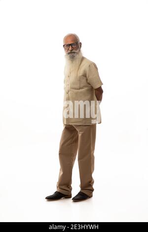 UN HOMME BARBU DEBOUT ET REGARDANT SÉRIEUSEMENT LOIN Banque D'Images