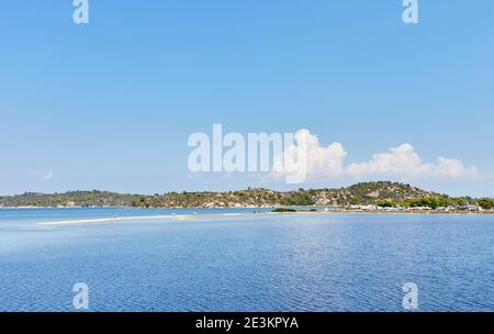 Regardez l'île de Diaporos au-dessus de la plage de Livari, Sithnonia, Halkidiki, Grèce; plateau d'eau peu profonde de mer Banque D'Images