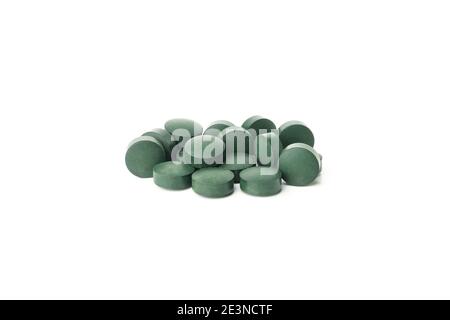Tas de pilules de spiruline isolées sur fond blanc Banque D'Images