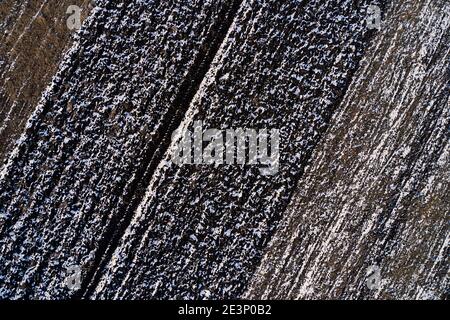 Texture du champ labouré gelé par le dessus, photographie de drone. Terres agricoles en hiver. Banque D'Images