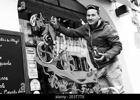 ESPELETTE, FRANCE - AVRIL 27, 2018: Homme dessinant une décoration amusante accueillant les participants de la course cycliste Tour de France qui passera à Espelette Banque D'Images
