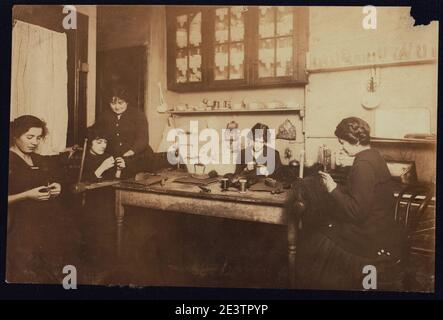 Fabrication de cheveux dans la cuisine-salle de séjour de H. Mowshowitz's, un entrepreneur, 178 E. 2nd St., N.Y. les puffs et interrupteurs en partie faits étaient couchés sur le sol. L'appartement est petit et Banque D'Images