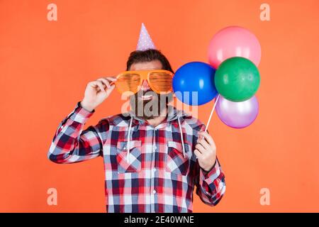 fêtez votre anniversaire. fêtes de fin d'année pour les hommes. barbu avec ballons de fête. homme brutal avec barbe. célébrez le succès de votre entreprise. exprimez votre pur bonheur. Banque D'Images