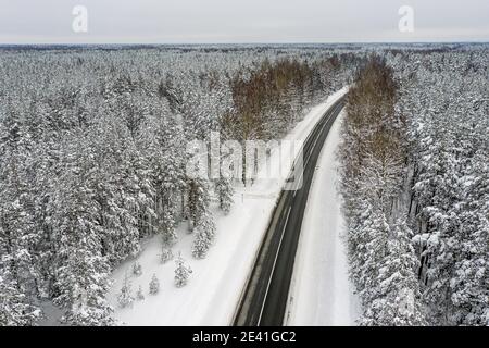 hiver forêt de conifères enneigée et la route d'un oeil d'oiseau vue Banque D'Images