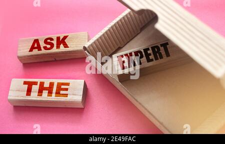 Demandez à l'expert des mots sur des blocs de bois. Poser dans la boîte et à l'extérieur Consulting un professionnel pour le conseil concept d'affaires. Banque D'Images