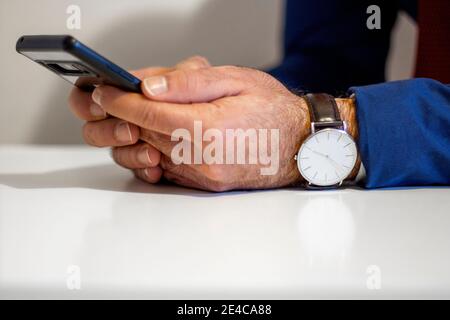 Gros plan sur un blanc avec un smartphone tableau Banque D'Images