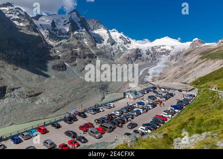 Parking visiteurs, vue de Kaiser-Franz-Josefs-Höhe au glacier de Pasterze avec Pasterzengrund, lac nouvellement créé, Hohenwartkopf sur la gauche, 3308 m, Adlersruhe, Großglockner, 3798 m, Hofmannspitze, 3722 m, à l'arrière Johannisberg, 3453 m, parc national Hohe Tauern, Autriche Carinthie Banque D'Images