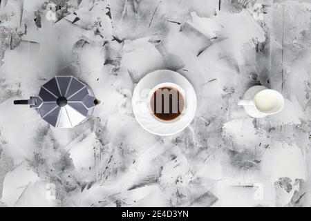 Vue de dessus de la machine à café geyzsr, tasse et pot avec lait sur fond abctract Banque D'Images