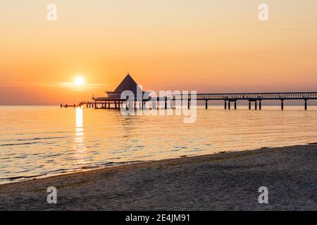 Allemagne, Mecklembourg-Poméranie occidentale, Heringsdorf, plage côtière de sable au lever du soleil avec l'embarcadère d'Heringsdorf en arrière-plan Banque D'Images