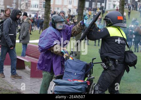 Amsterdam, pays-Bas. 24 janvier 2021. Un manifestant anti-verrouillage réagit contre un policier néerlandais anti-émeute lors d'une manifestation illégale anti-verrouillage au Museumplein dans le contexte de la pandémie du coronavirus le 24 janvier 2021 à Amsterdam, pays-Bas. (Photo de Paulo Amorim/Sipa USA) Credit: SIPA USA/Alay Live News Banque D'Images