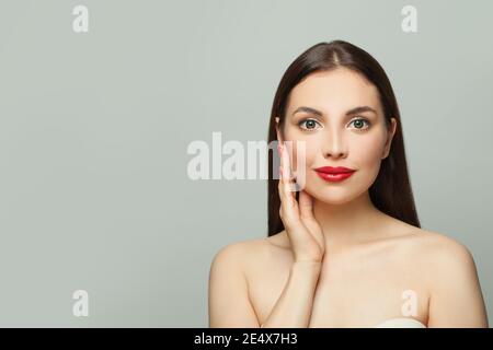 Belle femme avec une peau saine et claire sur blanc. Concept de soin de la peau et de soin du visage Banque D'Images