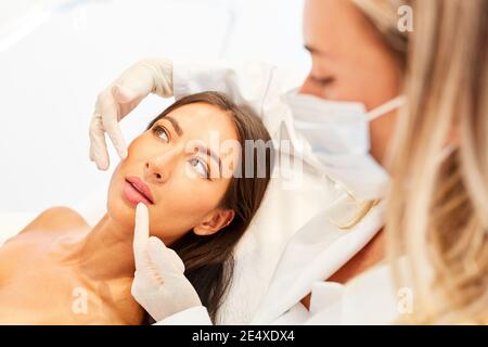 Patient et médecin donnant des conseils sur un visage ou une peau traitement Banque D'Images