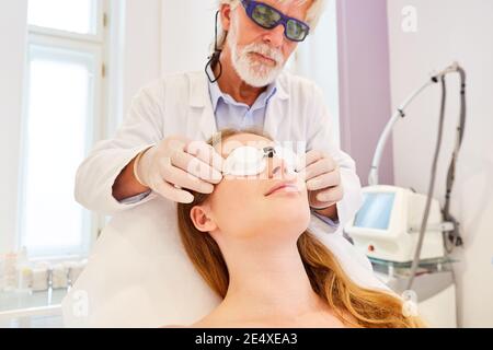 Le dermatologue vérifie les lunettes de protection sur le patient avant le traitement au laser pour rajeunissement de la peau Banque D'Images