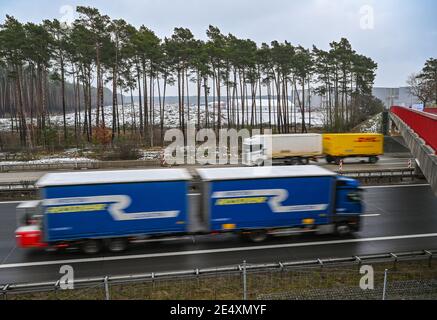 25 janvier 2021, Brandebourg, Grünheide: Des camions sont passés devant le chantier de construction du Gigafactory de Tesla, sur le périphérique est de Berlin de l'Autobahn 10. Un maximum de 500,000 véhicules par an doit sortir de la chaîne de production à l'usine à partir de juillet 2021 - le constructeur automobile prévoit d'atteindre le maximum le plus rapidement possible. Pour l'instant, le constructeur automobile américain prévoit d'employer jusqu'à 10,500 personnes par quart dans sa première usine prévue en Europe. Photo: Patrick Pleul/dpa-Zentralbild/ZB Banque D'Images