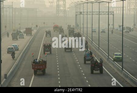 Un groupe de tracteurs se dirige vers l'autoroute Delhi-Meerut pendant la démonstration. Les agriculteurs sont tous équipés pour effectuer une marche sur les tracteurs le jour de la République mardi. Le syndicat des agriculteurs a conclu dimanche un accord avec la police de Delhi pour mener la marche pacifique des tracteurs, les agriculteurs protestant aux frontières de Delhi contre les lois du Centre sur les exploitations agricoles. Banque D'Images