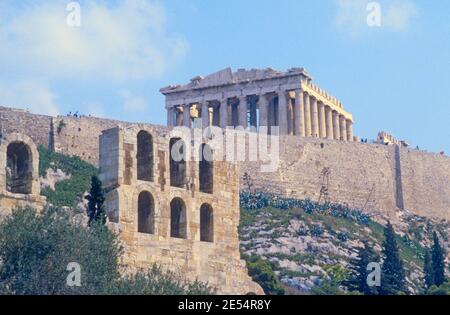 1986 Athènes Grèce - Théâtre de Dionysos vu de l'Acropole d'Athènes colline de l'Acropole. Le Théâtre de Dionysos ou Théâtre de Dionysos est un ancien théâtre d'Athènes sur la pente sud de la colline d'Akropolis, construit comme partie du sanctuaire de Dionysos Eléeutheus. Il aurait eu une capacité de 17,000 personnes. Vue sur le Parthénon sur la colline de l'Acropole à travers le Théâtre de Dionysos sur l'Acropole Athènes Grèce UE Europe Banque D'Images