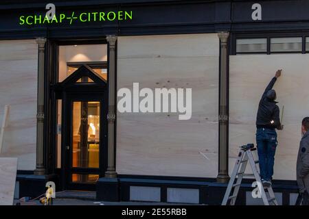 MAASTRICHT, PAYS-BAS, JANVIER 26: Les propriétaires de magasins sont vus barricader les fenêtres de leurs entreprises le 26 janvier 2021 à Maastricht, Les pays-Bas doivent éviter les pillages car les autorités sont en alerte pour des émeutes pour la troisième nuit consécutive après que le gouvernement néerlandais ait mis en place un couvre-feu pour arrêter la propagation du coronavirus. (Photo de Frank Curbusch/BSR Agency/Alay Live News) Banque D'Images