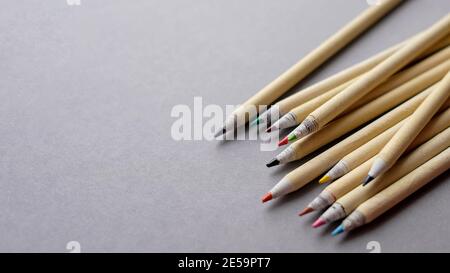 Les crayons fabriqués à partir de matériaux écologiques se trouvent sur un fond gris. Il y a une place pour le texte. Banque D'Images