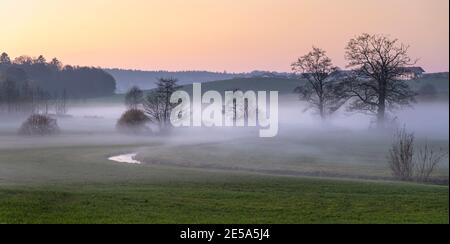 Brouillard montant dans une petite vallée fluviale en automne , Allemagne, Bavière Banque D'Images