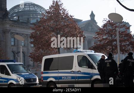 Berlin, Allemagne. 27 janvier 2021. Des policiers se trouvent à côté des voitures d'escouade devant le bâtiment Reichstag à Berlin. Credit: Dorothee Barth/dpa/Alay Live News Banque D'Images