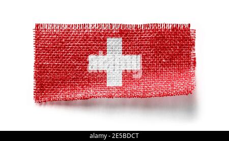 Drapeau suisse sur un morceau de tissu sur un blanc arrière-plan Banque D'Images