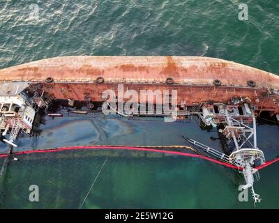 Un pétrolier nauséeux en contrebas se trouvant sur les mers délavées au large de la côte. Banque D'Images