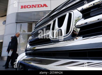Visitors look at a Honda Motor Cou0027s car displayed outside the