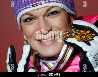 Bronze medal winner Maria Hoefl-Riesch of Germany poses with her medals during the podium ceremony for the women's Downhill race at the World Alpine Skiing Championships in Schladming February 10, 2013.  REUTERS/Dominic Ebenbichler (AUSTRIA - Tags: SPORT SKIING PROFILE)